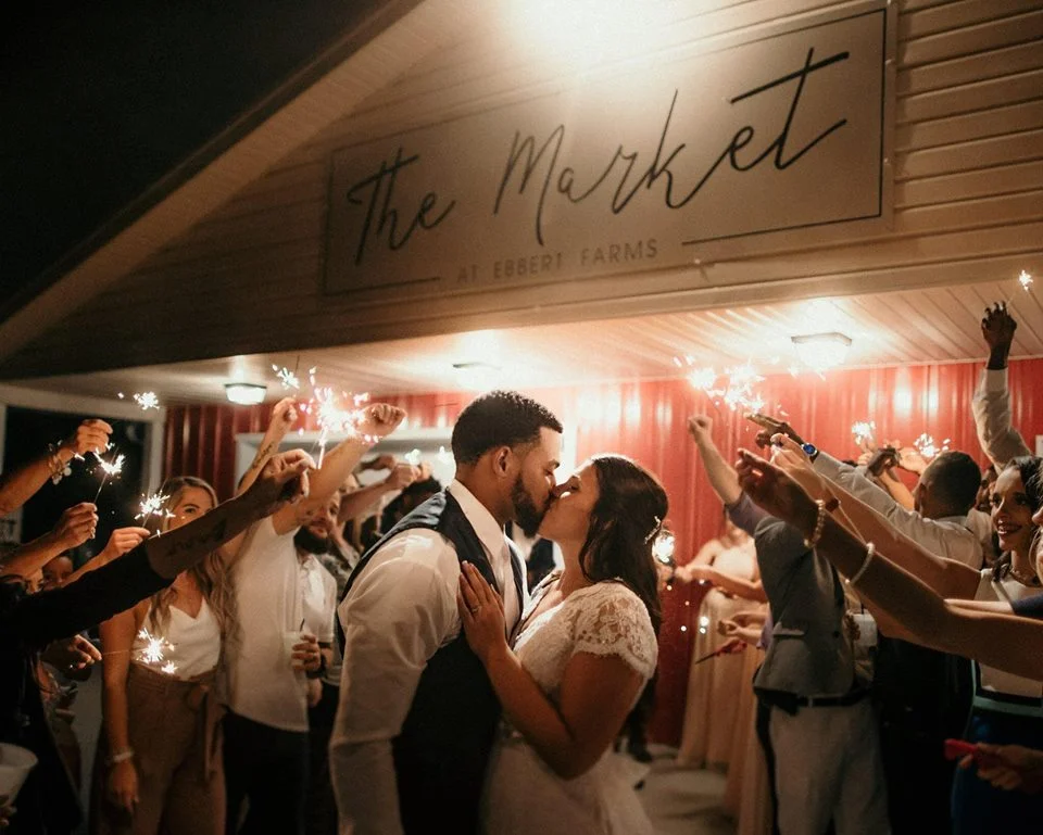 A couple celebrates their wedding with loved ones at "The Market" on Ebbert Farms.